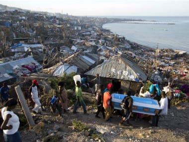 Residents carry a coffin containing the remains of a pregnant woman, a victim of Hurricane Matthew, in Jeremie, Haiti on Friday. AP