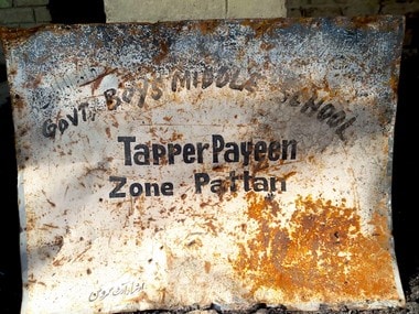 The damaged signboard of Government Boys Middle School, Tapper in north Kashmir’s Pattan area. Pic courtesy: Sameer Yasir.