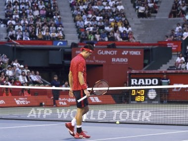 Kei Nishikori walks on the center court as he retires from his match against Joao Sousa. AP