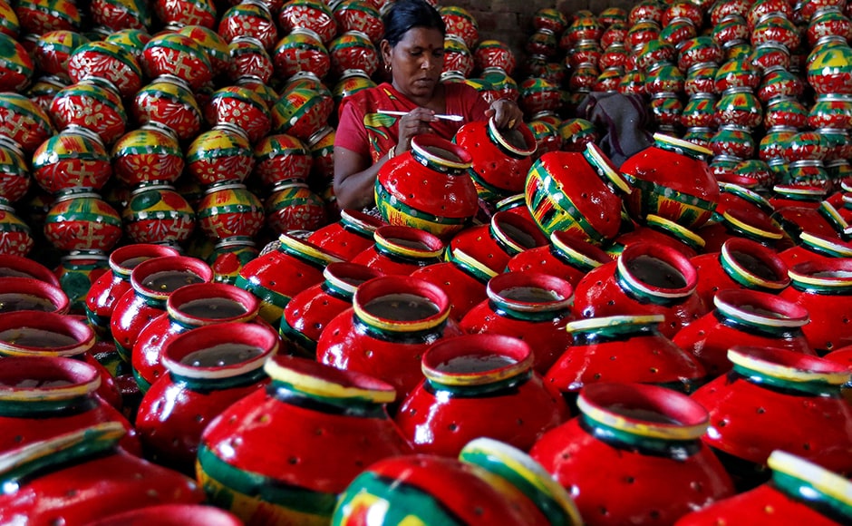 A woman decorates an earthen pitcher used during Garba inside a workshop. During Navratri, feasting and fasting takes over normal life for millions of Indians, and many people join in religious dances in the evenings. Reuters A woman decorates an earthen pitcher used during Garba inside a workshop. During Navratri, feasting and fasting takes over normal life for millions of Indians, and many people join in religious dances in the evenings. Reuters