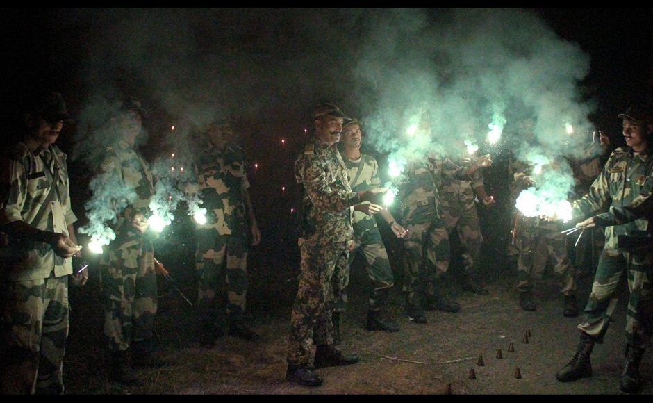 BSF jawans celebrating Diwali near the India-Bangladesh border in South Dinajpur district of West Bengal on Friday. (Photo: PTI) BSF jawans celebrating Diwali near the India-Bangladesh border in South Dinajpur district of West Bengal on Friday. (Photo: PTI)