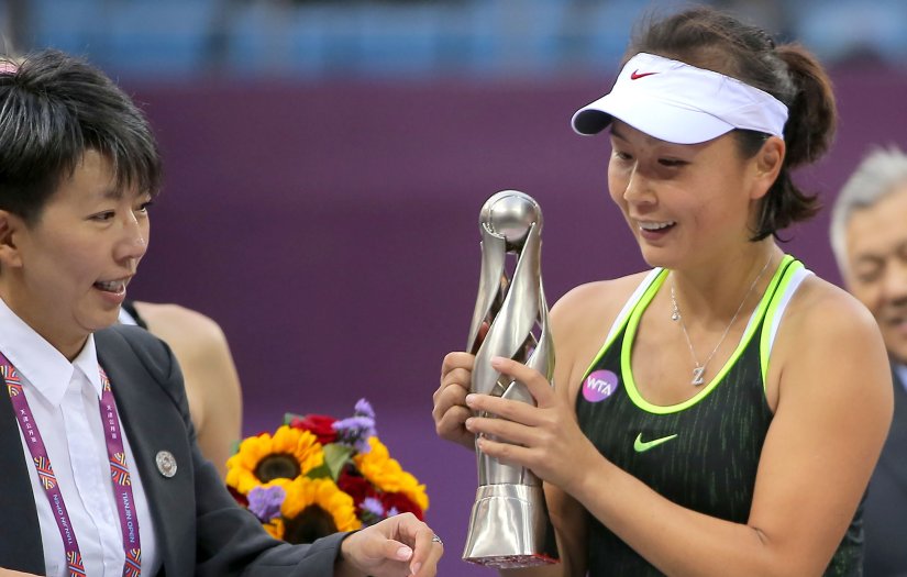 Peng Shuai of China looks at her trophy after winning the final match against Alison Riske at the Tianjin Open. AFP