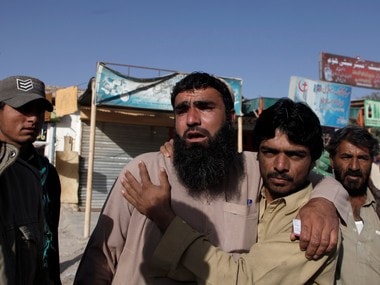 Relatives of police cadets wait for word outside the Police Training Center after an attack on the center in Quetta, Pakistan on 25 October. Reuters