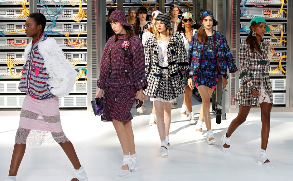 Models walking alongside rows of computer hardware wore classic Chanel tweed suits and jackets completed with metallic ballerina shoes. REUTERS/Charles Platiau Models walking alongside rows of computer hardware wore classic Chanel tweed suits and jackets completed with metallic ballerina shoes. REUTERS/Charles Platiau