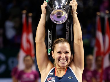 Dominika Cibulkova of Slovakia celebrates after beating Angelique Kerber of Germany in their women's singles final match at WTA finals. AP
