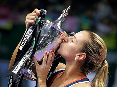 Dominika Cibulkova of Slovakia kisses her trophy after beating Angelique Kerber of Germany in their women's singles final match at the WTA tournament in Singapore. AP