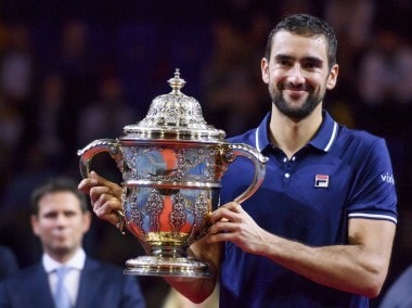 Marin Cilic poses with the trophy after winning the final against Kei Nishikori. AFP