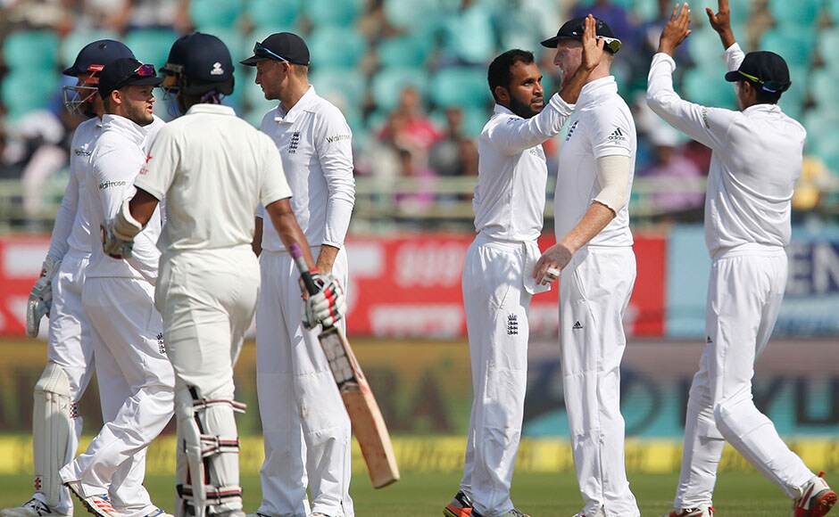 England's Adil Rashid, third right, celebrates with teammates the dismissal of India's Wriddhiman Saha, third left, on the fourth day of their second cricket test match in Visakhapatnam, India, Sunday, Nov. 20, 2016. (AP Photo/Aijaz Rahi)