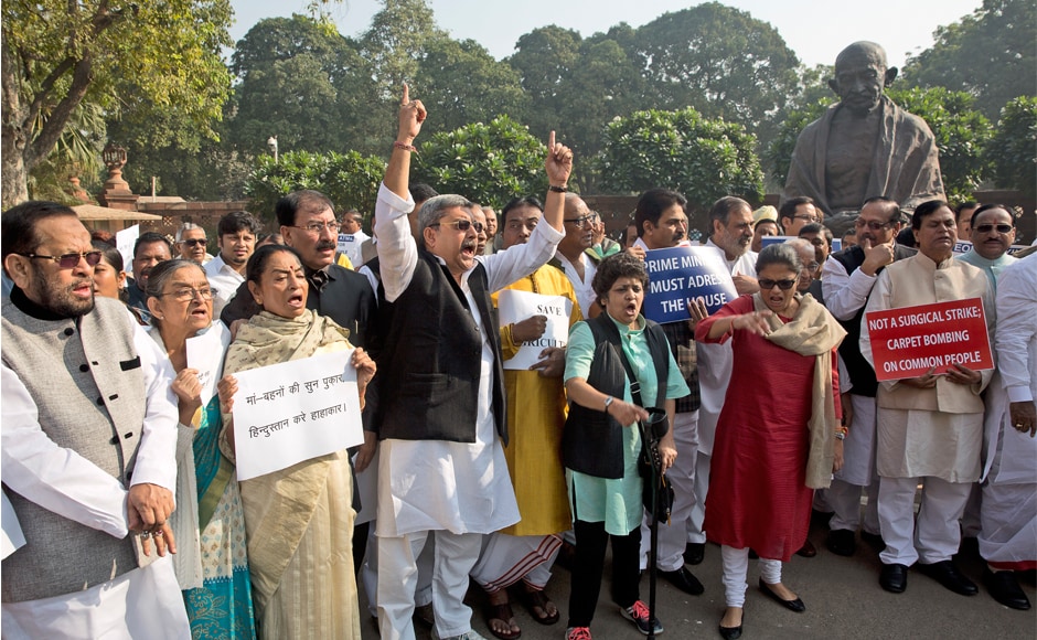 Opposition MPs including those of Congress, SP, BSP, TMC, DMK, CPI, CPI(M) among others were outside Parliament near Gandhi Statue protesting the demonetisation. (Photo: AP) Opposition MPs including those of Congress, SP, BSP, TMC, DMK, CPI, CPI(M) among others were outside Parliament near Gandhi Statue protesting the demonetisation. (Photo: AP)