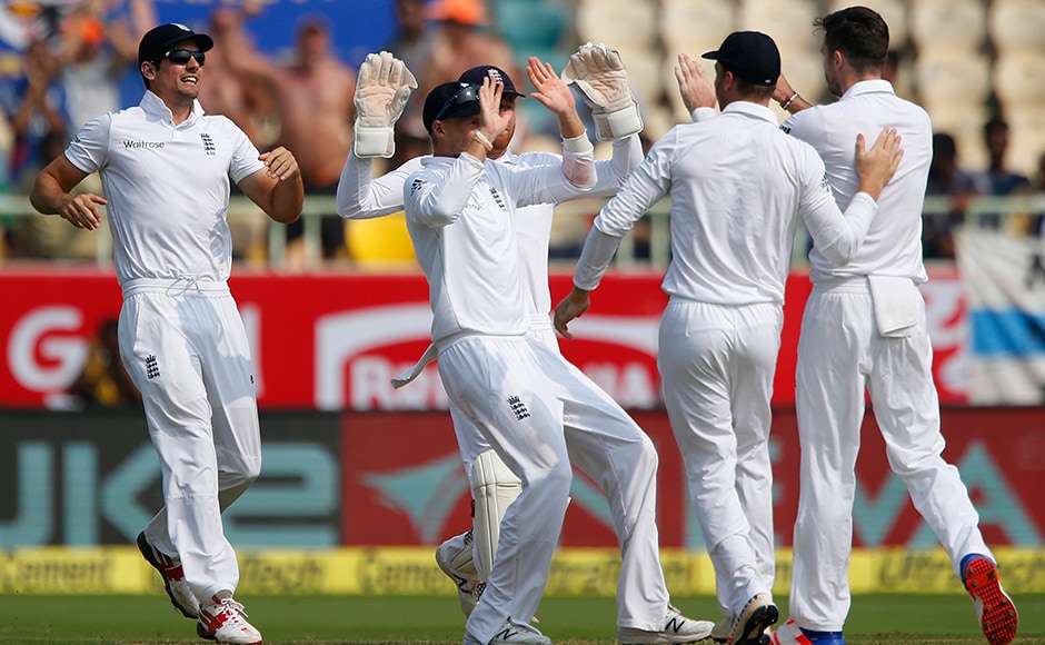 England's captain Alastair Cook, left, runs to celebrate with teammates the dismissal of India's Murali Vijay on the first day of their second cricket test match between India and England in Visakhapatnam, India, Thursday, Nov. 17, 2016. (AP Photo/Aijaz Rahi)