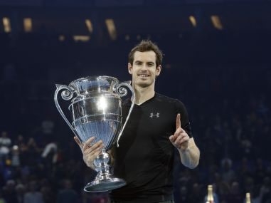 Andy Murray of Britain holds the trophy after winning the ATP World Tour Finals. AP