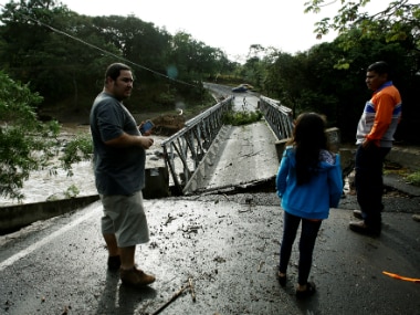 People gather near a bridge destroyed by Hurricane Otto in Guayabo de Bagaces, Costa Rica on Thursday. Reuters