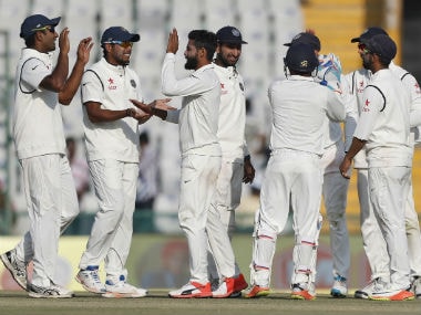 Indians celebrate the dismissal of England's Jos Buttler on Day 1 of 3rd Test match in Mohali. AP