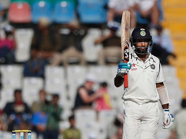 Pujara acknowledges the crowd his half-century on the Day 2 of 3rd Test against England in Mohali. AP