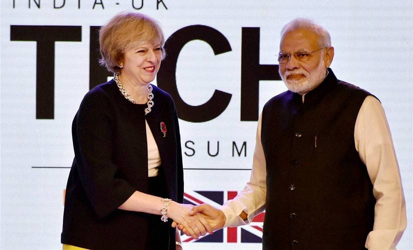 Prime Minister Narendra Modi shakes hands with UK counterpart Theresa May at the inauguration of India- UK Tech Summit. PTI