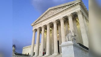 US Supreme Court hears arguments on Donald Trump's travel ban in day of full blown review
