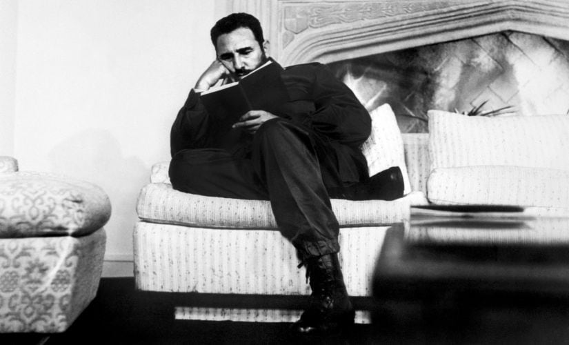 A 1971 photo where Castro is reading a book during a visit to Chile. AFP