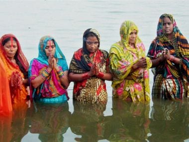 Devotees worshiping on the occasion of the Chhath festival on the banks of Ganga river at Varanasi on Sunday. PTI