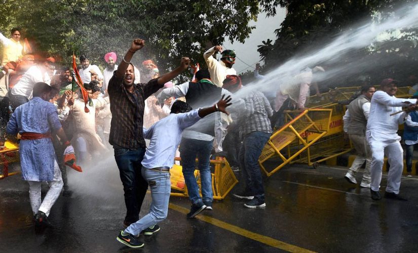 Security personnel use water cannon on Youth Congress activists during a protest against demonetisation in New Delhi on Friday. PTI
