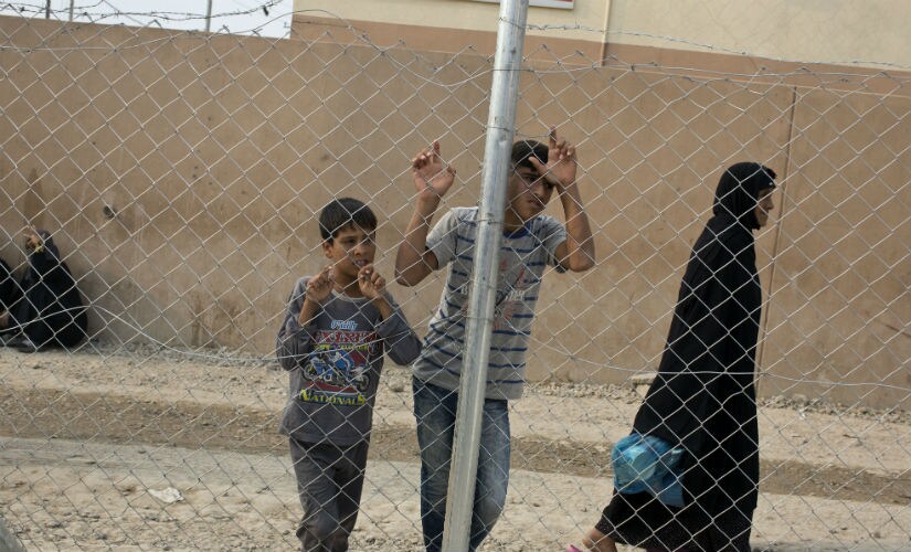 Children waiting for aid packages in Mosul. AP