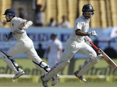 Pujara runs between the wicket with Vijay on the third day of the first Test between India and England. AP