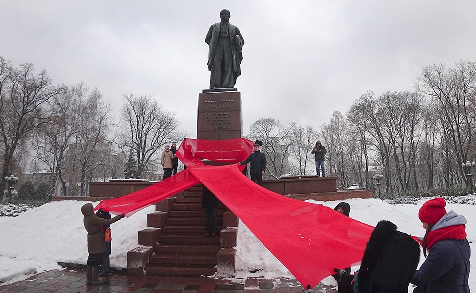 In Ukraine, the Activists remembered those who had lost their lives due to HIV/AIDS by holding a huge red ribbon in front of a monument to Taras Shevchenko, famous Ukrainian poet to mark the 'World AIDS Day' and in memory of those who have died of AIDS. AP In Ukraine, the Activists remembered those who had lost their lives due to HIV/AIDS by holding a huge red ribbon in front of a monument to Taras Shevchenko, famous Ukrainian poet to mark the 'World AIDS Day' and in memory of those who have died of AIDS. AP
