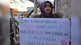 Muslim women respond to a hate crime by handing out roses at Forest Hill station