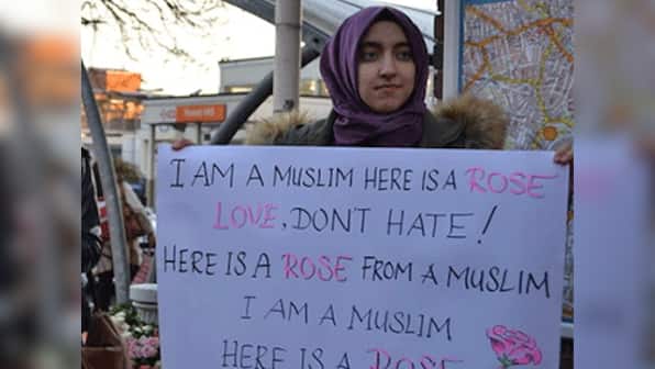 Muslim women respond to a hate crime by handing out roses at Forest Hill station
