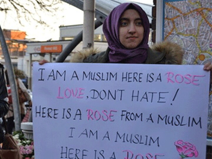 Muslim women respond to a hate crime by handing out roses at Forest Hill station