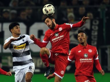 Gladbach's Mahmoud Dahoud, left, and Mainz' Yunus Malli challenge for the ball during the German Bundesliga soccer match between Borussia Moenchengladbach and Mainz 05 in Moenchengladbach, Germany, Sunday, Dec. 11, 2016. (Federico Gambarini/dpa via AP)