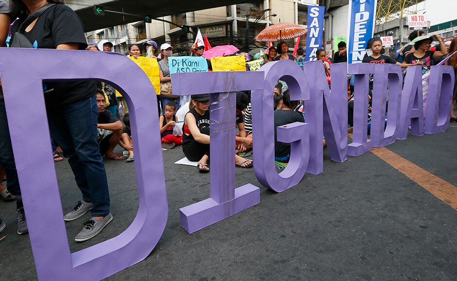 Protesters display the word Protesters display the word