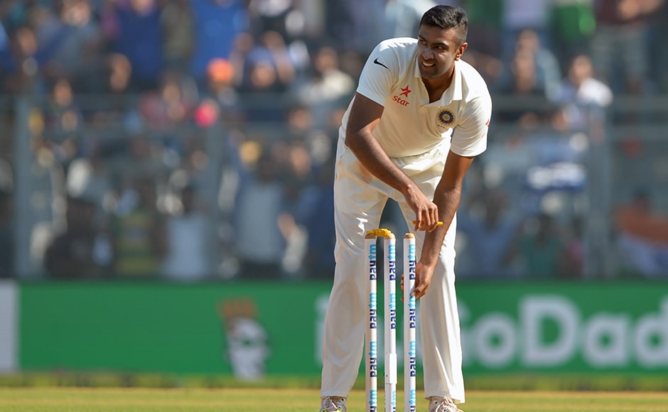 India's Ravichandran Ashwin pulls out the stumps as he celebrates after winning the fourth Test cricket match against England at the Wankhede stadium in Mumbai on December 12, 2016. / AFP PHOTO