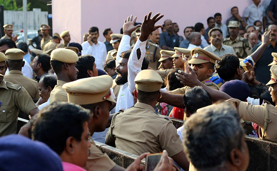 A supporter of India's Tamil Nadu state former Chief Minister Jayaram Jayalalithaa reacts on seeing body of Jayalalithaa wrapped in the national flag and kept for public viewing outside an auditorium in Chennai, India, Tuesday, Dec. 6, 2016. Jayalalithaa, the hugely popular south Indian actress who later turned to politics and became the highest elected official in the state of Tamil Nadu, died Monday. She was 68. (AP Photo/Aijaz Rahi)