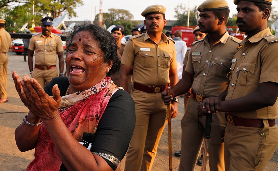 A supporter of India's Tamil Nadu state former Chief Minister Jayaram Jayalalithaa breaks down on seeing body of Jayalalithaa wrapped in the national flag and kept for public viewing outside an auditorium in Chennai, India, Tuesday, Dec. 6, 2016. Jayalalithaa, the hugely popular south Indian actress who later turned to politics and became the highest elected official in the state of Tamil Nadu, died Monday. She was 68. (AP Photo/Aijaz Rahi)