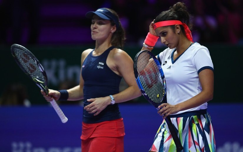 SINGAPORE - OCTOBER 29: Sania Mirza (R) of India and Martina Hingis of Switzerland look dejected in their doubles semi-final against Elena Vesnina and Ekaterina Makarova of Russia during day 7 of the BNP Paribas WTA Finals Singapore at Singapore Sports Hub on October 29, 2016 in Singapore. (Photo by Clive Brunskill/Getty Images)