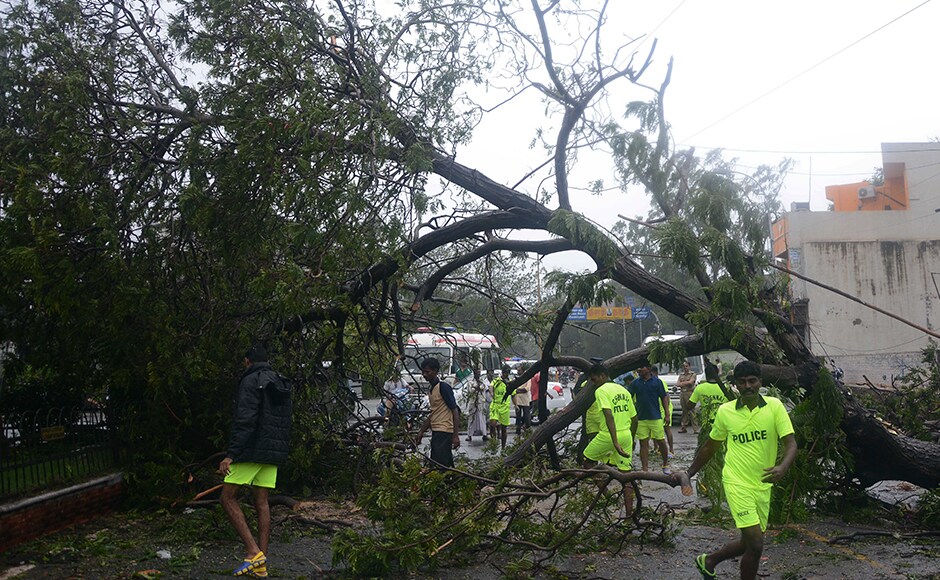 Residents walk along a street strewn with debris and fallen trees in Chennai as Cyclone Vardah approaches the Indian coast. AFP Residents walk along a street strewn with debris and fallen trees in Chennai as Cyclone Vardah approaches the Indian coast. AFP