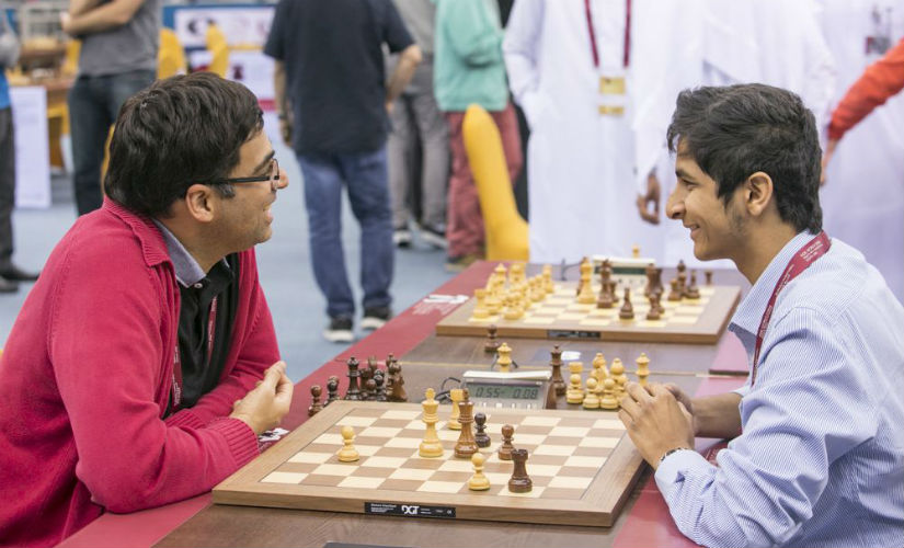 Two generations of Indian chess, Anand and Vidit Gujrathi share a light moment after they drew their round three game against each other. Image courtesy: Maria Emelianova