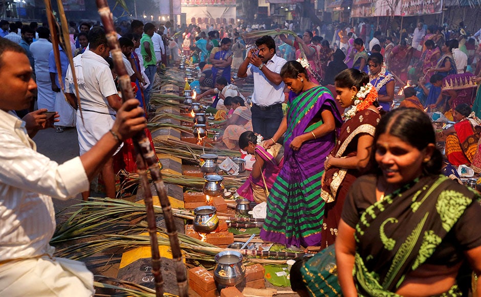 Devotees prepare rice dishes to offer to the Hindu Sun God as they attend Pongal celebrations early morning in Mumbai, India, January 14, 2017. REUTERS/Shailesh Andrade Devotees prepare rice dishes to offer to the Hindu Sun God as they attend Pongal celebrations early morning in Mumbai, India, January 14, 2017. REUTERS/Shailesh Andrade