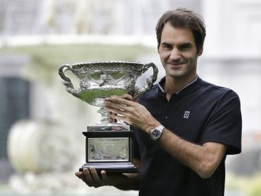 Roger Federer poses for photos with his Australian Open trophy. AP