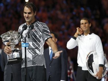 Roger Federer addresses spectators, holding his trophy, after defeating Rafael Nadal. AP