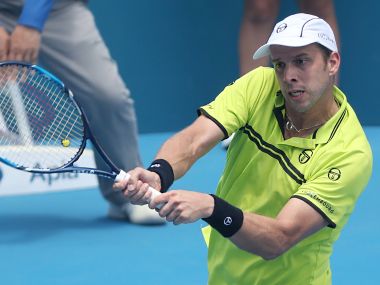 Gilles Muller hits a return to Pablo Cuevas of Uruguay in their quarter-final at the Sydney International. AFP
