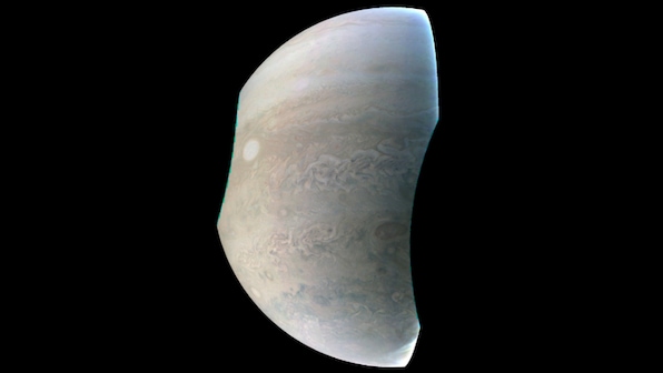 Juno probe reveals crescent shaped Jupiter with iconic Great Red Spot