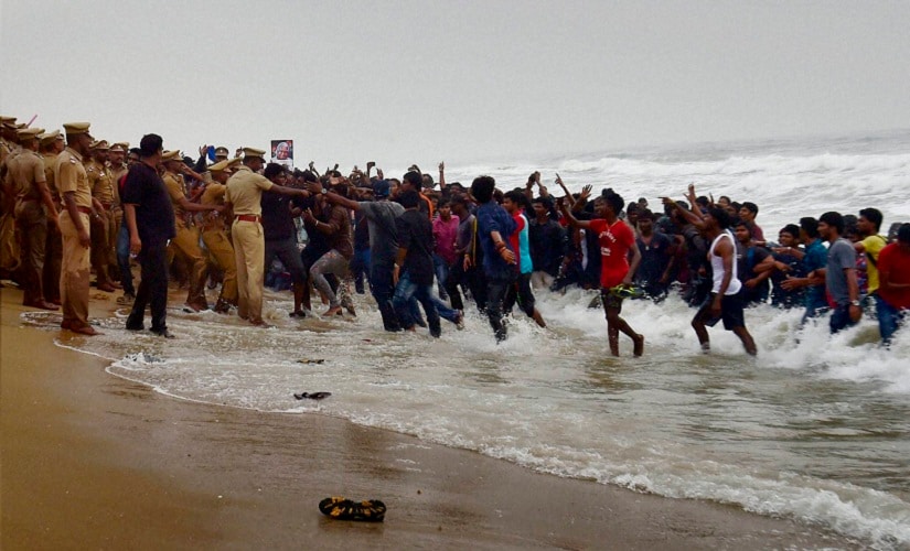 Police try to evict Pro-Jallikattu protesters from the Marina Beach in Chennai on Monday. PTI