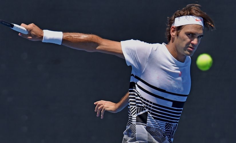 Roger Federer hits a return during a practice session ahead of the Australian Open. AFP