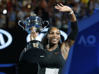 Serena Williams holds her Australian Open trophy after defeating her sister, Venus. AP