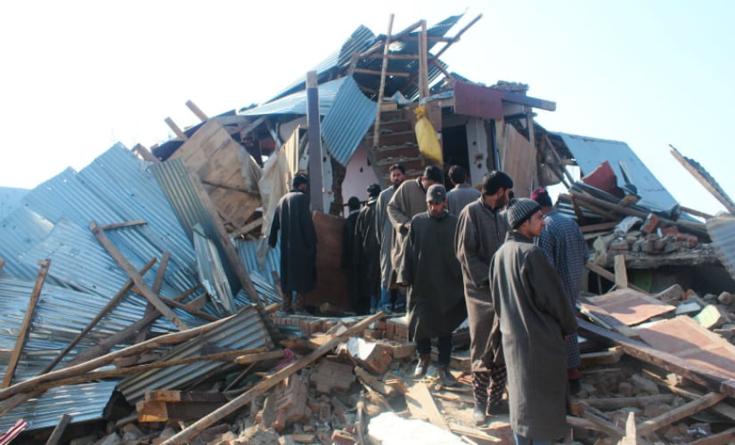People standing near the debris of a demolished house wherein three top Lashkar-e-Taiba militants were killed in a fierce gunbattle with security forces at North Kashmir's Hajin area. Firstpost/Suhail Bhat