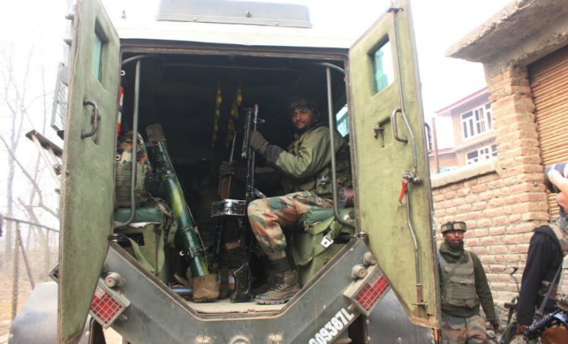 An army personal sits with his guns inside an armored vehicle after the end of a 48-hour long gunbattle in South Kashmir’s Arwani Hamlet. Firstpost/Suhail Bhat
