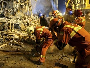 Iranian firefighters start to dig a tunnel to make a corridor under the 17-storey Plasco building which collapsed after being engulfed by a fire, in central Tehran, Iran, Thursday. AP