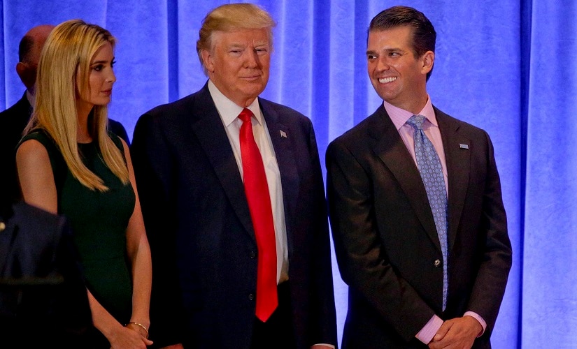 US President-elect Donald Trump waits with family members Ivanka Trump (left) and Donald Trump Jr. before speaking at a news conference on Wednesday. AP