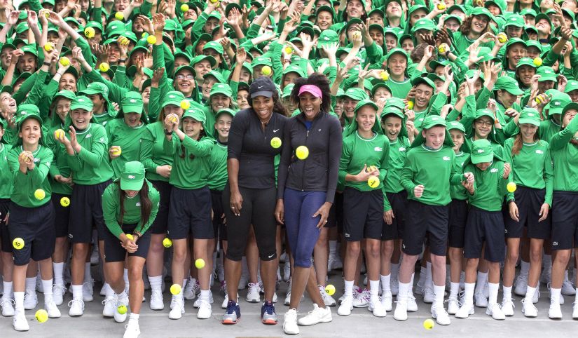 Serena Williams and her sister Venus pose with Australia Open ballkids in Melbourne. AFP